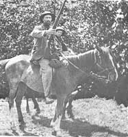 Boer father and son prepare to expel the invaders. 